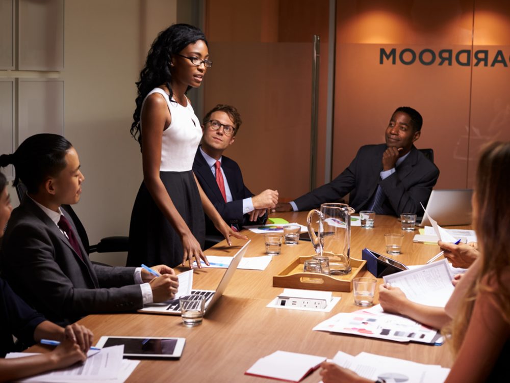 Woman giving a presentation to a boardroom