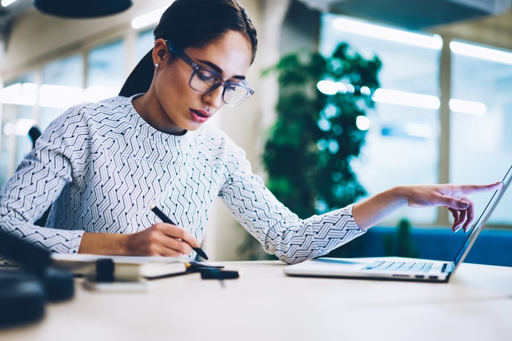 Businesswoman pensively working at laptop