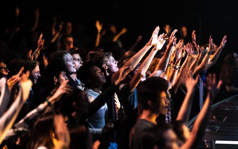 Church crowd worshipping with hands up