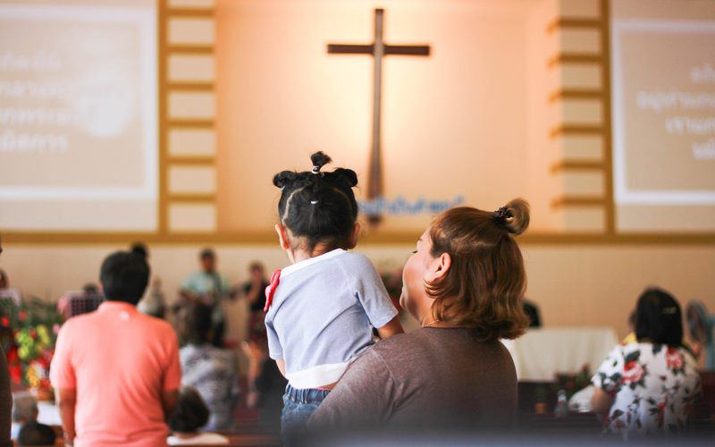 Woman holding baby in church session